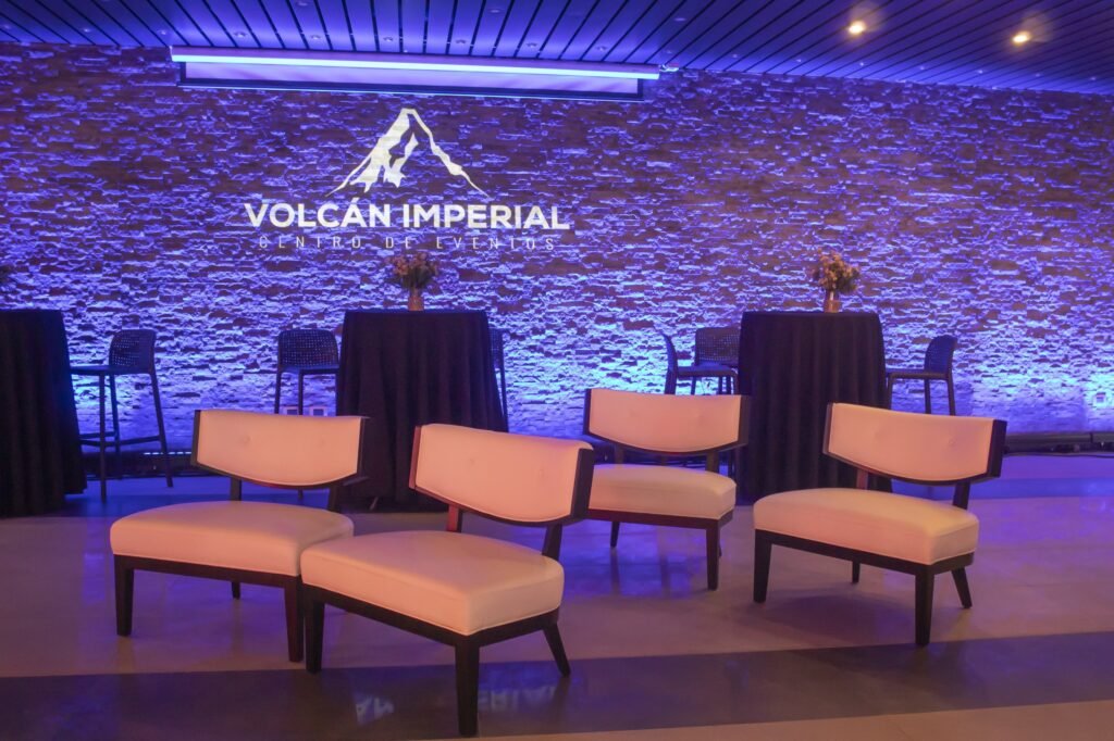 Lounge con muro de piedra y logo de Volcán Imperial